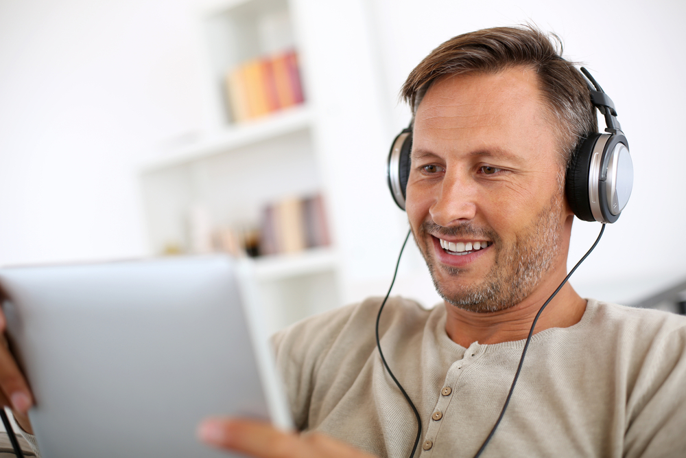 Man playing Corporate Virtual Game with Colleagues on Tablet