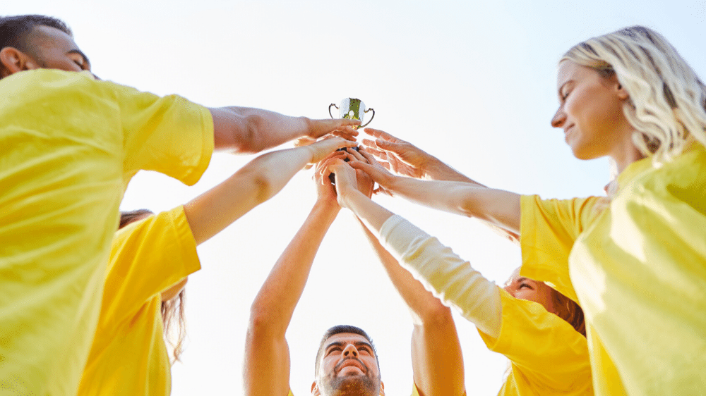 People standing around a trophy after a team building event